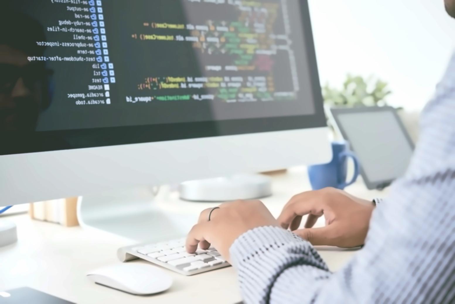 Students collaborating on game development project with multiple monitors showing code and game prototypes