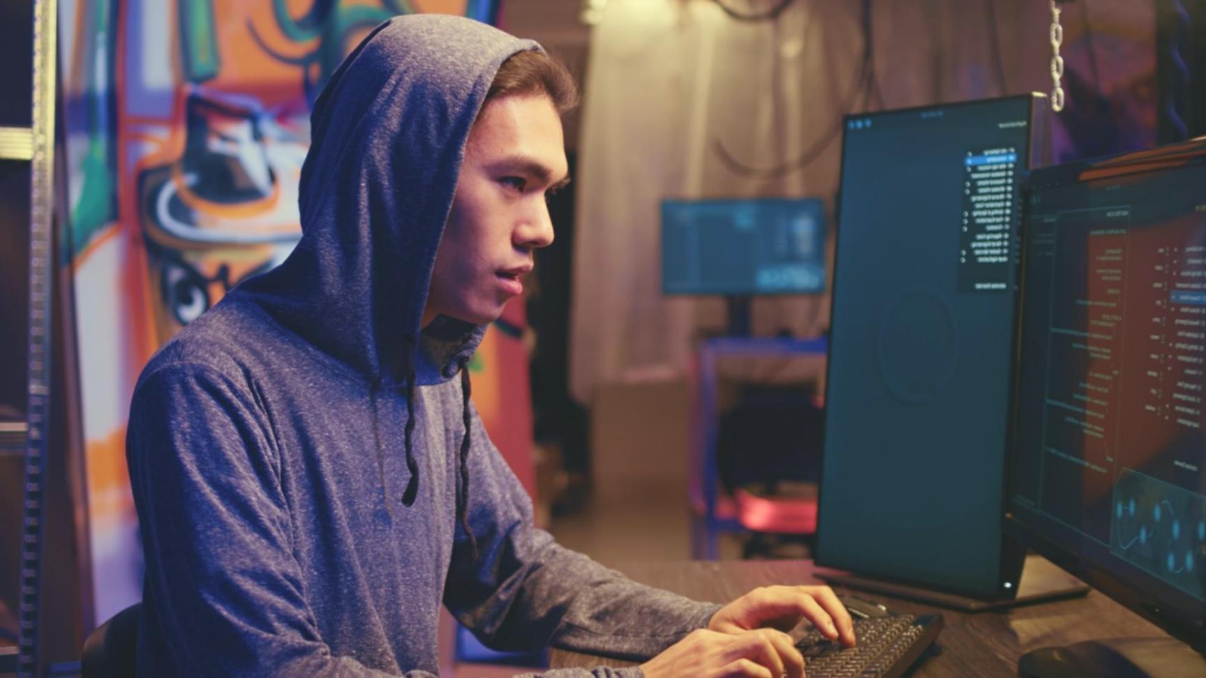 Game development workspace with multiple monitors showing code and game engines